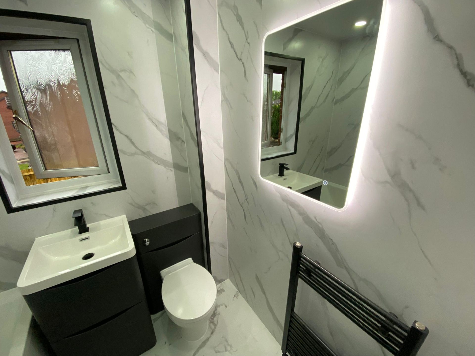 Luxury bathroom transformation showing before and after wetwall installation in Glasgow home